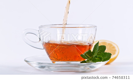 pouring tea to a teacup 74658311