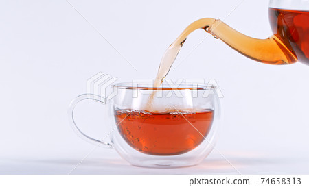 pouring tea to a teacup 74658313