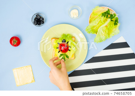 Fun food art for kids. Ladybug sandwich on blue background. How to make creative breakfast for kid at home. Step by step instruction, view from above. Step . Fun food art for kids. Ladybug sandwich on blue background. How to make creative breakfast for kid at home. Step by step instruction, view from above. Step . 74658705