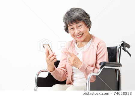 Long-term care image Wheelchair Senior woman making a video call Long-term care image Wheelchair Senior woman making a video call 74658838