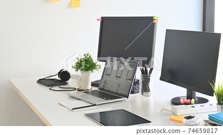 Workspace programmer with laptop and computer pc on table. Workspace programmer with laptop and computer pc on table. 74659817
