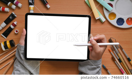 Above of creative designer hands is holding a white blank screen tablet. 74660516
