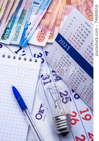 calendar 2021 and money, money and light bulb, calendar and Notepad with pen calendar 2021 and money, money and light bulb, calendar and Notepad with pen 74660616