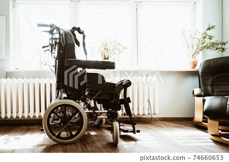 an empty handicap chair in a clinic an empty handicap chair in a clinic 74660653