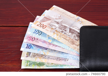New money from Qatar in the black wallet 74660790