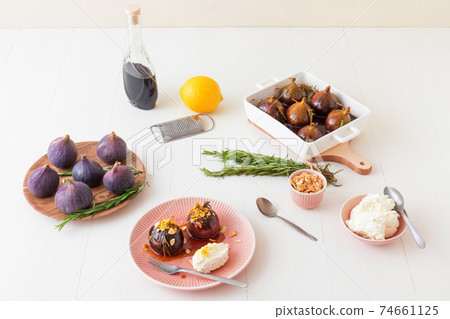 Caramelised figs with balsamic vinegar, rosemary, almonds and cottage cheese. Slow roasted homemade fruit dessert. White wooden table background. No people. Gordon Ramsey recipe. Caramelised figs with balsamic vinegar, rosemary, almonds and cottage cheese. Slow roasted homemade fruit dessert. White wooden table background. No people. Gordon Ramsey recipe. 74661125