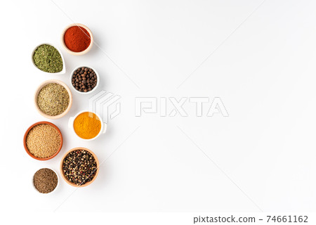 Overhead shot of seasonings in bowls isolated on white background with copyspace 74661162