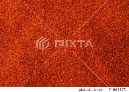 Red paprika powder texture. Background with copyspace. Close up. Top view Red paprika powder texture. Background with copyspace. Close up. Top view 74661175