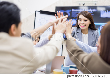 Coworkers discuss at table 74661210