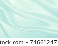 Smooth elegant blue silk or satin luxury cloth texture as abstract background. Luxurious background design 74661247