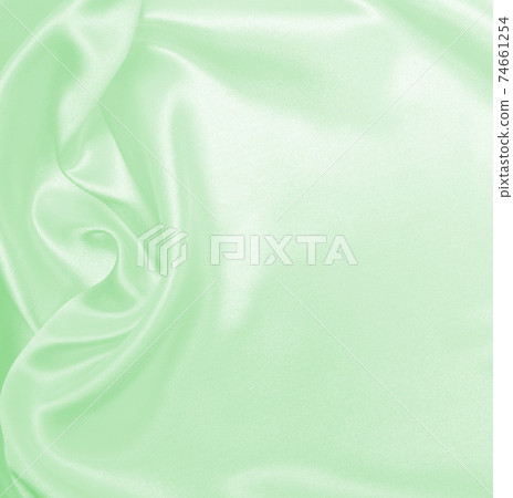 Smooth elegant green silk or satin luxury cloth texture as abstract background. Luxurious background design 74661254