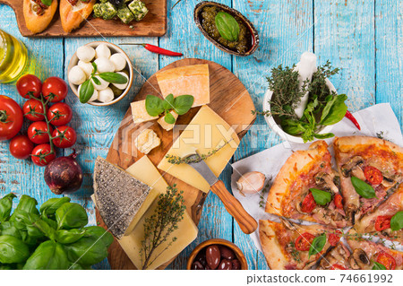Various kind of italian food served on vintage wooden table. Various kind of italian food served on vintage wooden table. 74661992