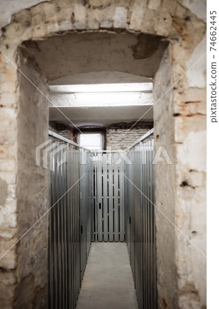 a hallway inside of a basement between the units 74662445