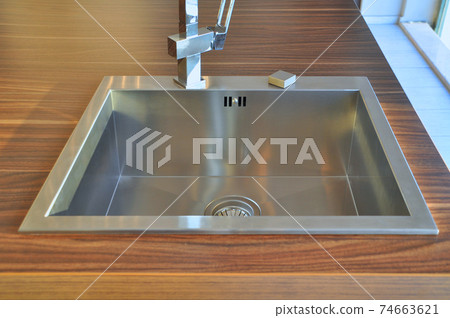 Interior of modern kitchen and stainless steel sink, tap and drain Interior of modern kitchen and stainless steel sink, tap and drain 74663621