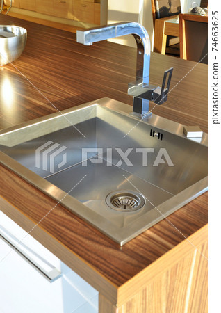 Interior of modern kitchen and stainless steel sink, tap and drain Interior of modern kitchen and stainless steel sink, tap and drain 74663625