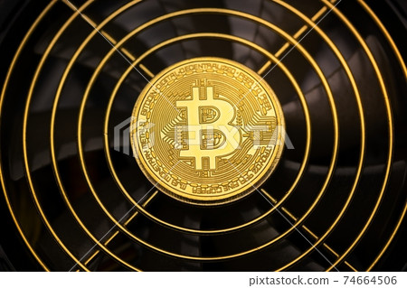 Physical shiny bitcoin agains dark background 74664506
