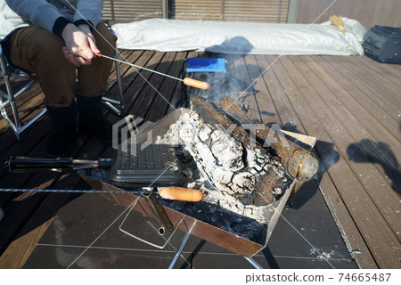 Bake sausages on a bonfire 74665487
