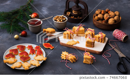 Baking with love for Merry Christmas. Baking Christmas cookies. Dark background table. 74667068