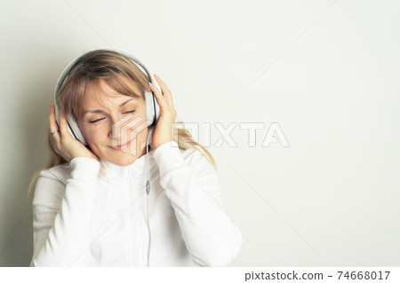 Woman enjoying music with headphones Woman enjoying music with headphones 74668017