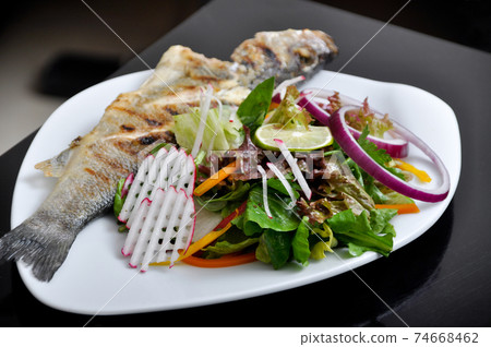 Delicious and a nice grilled fish and salads 74668462