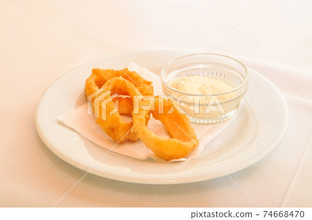 Fresh fried squid rings and special sauce in white plate Fresh fried squid rings and special sauce in white plate 74668470