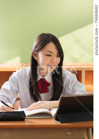 High school girls studying on tablets High school students 74668682