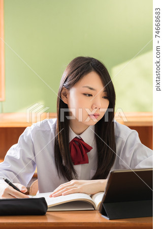 High school girls studying on tablets High school students High school girls studying on tablets High school students 74668683