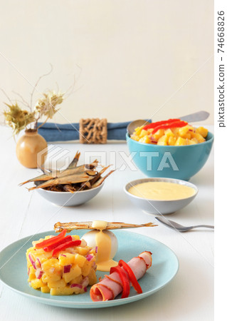 Henri Egg, tasty fresh brunch or snack. Henri Egg, tasty brunch or snack. Boiled eggs and smoked sprats fish with mayonnaise, ham and potato salad. White wooden table, no people. Henri Egg, tasty fresh brunch or snack. Henri Egg, tasty brunch or snack. Boiled eggs and smoked sprats fish with mayonnaise, ham and potato salad. White wooden table, no people. 74668826