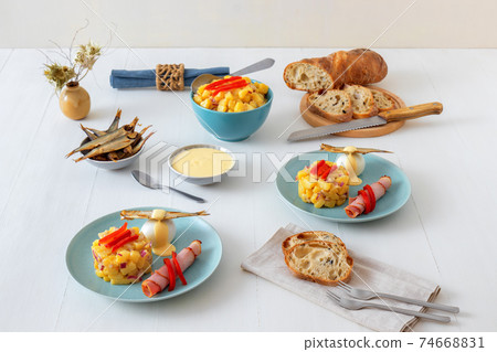Henri Egg, tasty fresh brunch or snack. Henri Egg, tasty brunch or snack. Boiled eggs and smoked sprats fish with mayonnaise, ham and potato salad. White wooden table, no people. Henri Egg, tasty fresh brunch or snack. Henri Egg, tasty brunch or snack. Boiled eggs and smoked sprats fish with mayonnaise, ham and potato salad. White wooden table, no people. 74668831
