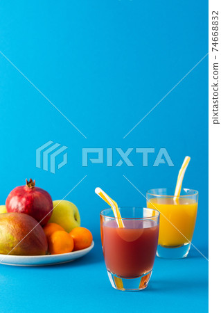 Juices in glasses and ripe fruits Juices in glasses and ripe fruits 74668832