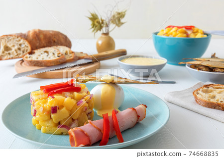 Henri Egg, tasty fresh brunch or snack. Henri Egg, tasty brunch or snack. Boiled eggs and smoked sprats fish with mayonnaise, ham and potato salad. White wooden table, no people. Henri Egg, tasty fresh brunch or snack. Henri Egg, tasty brunch or snack. Boiled eggs and smoked sprats fish with mayonnaise, ham and potato salad. White wooden table, no people. 74668835