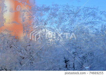 Texture as a frosty pattern on a window glass as a close up Texture as a frosty pattern on a window glass as a close up 74669255