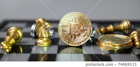 golden Bitcoin cryptocurrency coin stack and Chess piece on chessboard, Crypto is Digital Money of blockchain network, is exchanged using technology and online internet exchange. Financial concept golden Bitcoin cryptocurrency coin stack and Chess piece on chessboard, Crypto is Digital Money of blockchain network, is exchanged using technology and online internet exchange. Financial concept 74669515
