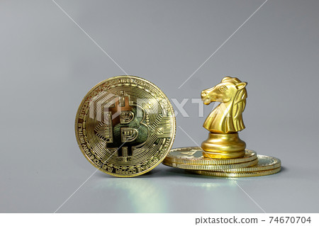 golden Bitcoin cryptocurrency coin stack and Chess Knight piece, Crypto is Digital Money within the blockchain network, is exchanged using technology and online internet exchange. Financial concept 74670704