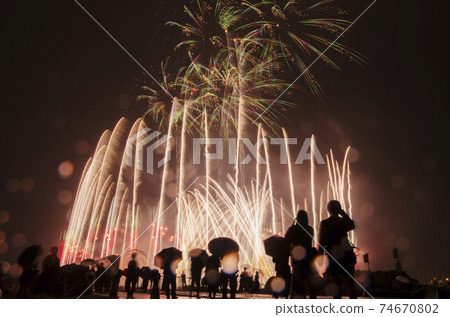 Fireworks rising high in the night sky Fireworks on a rainy day 74670802
