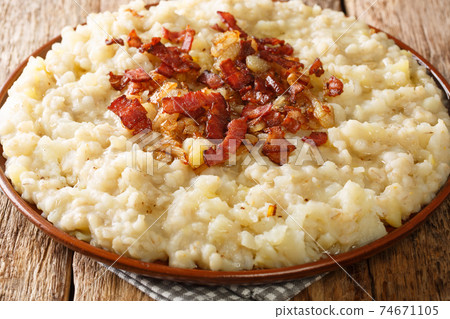 Mulgipuder is a rustic Estonian porridge consisting of mashed barley and potatoes closeup in the plate. Horizontal Mulgipuder is a rustic Estonian porridge consisting of mashed barley and potatoes closeup in the plate. Horizontal 74671105
