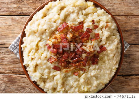 Mulgipuder is a rustic Estonian porridge consisting of mashed barley and potatoes closeup in the plate. Horizontal top view Mulgipuder is a rustic Estonian porridge consisting of mashed barley and potatoes closeup in the plate. Horizontal top view 74671112