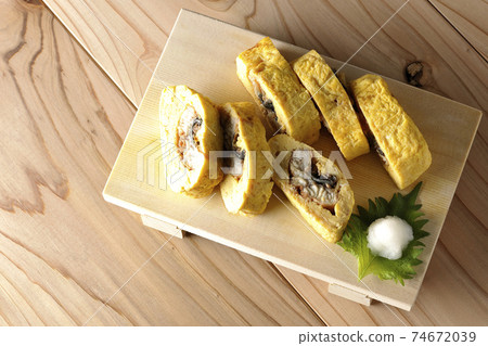 A bird's-eye view of the eel rolls served on sushi clogs A bird's-eye view of the eel rolls served on sushi clogs 74672039