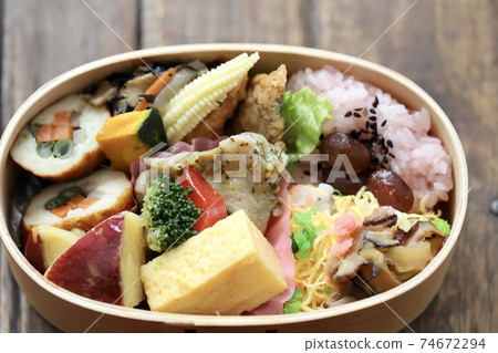A Japanese bento packed with side dishes in a bento box 74672294