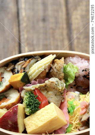 A Japanese bento packed with side dishes in a bento box 74672295