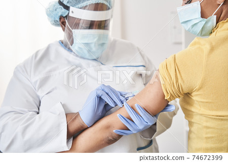 Caucasian girl receiving vaccine while standing in hospital 74672399