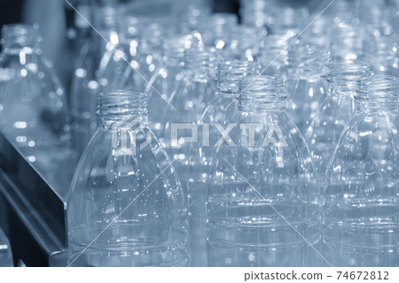The PET bottles  on the conveyor belt for filling process. 74672812