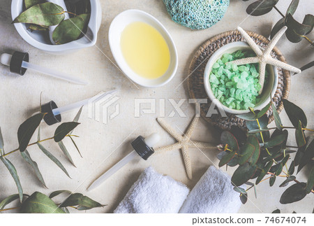 Healthcare concept with fresh eucalyptus leaves, salt and oil on stone background 74674074