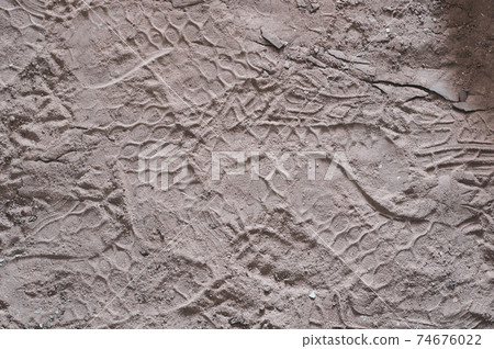Sand on beach, many footprints in sand, textured surface, horizontal photography, natural material, outdoors close-up Sand on beach, many footprints in sand, textured surface, horizontal photography, natural material, outdoors close-up 74676022