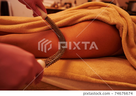 Closeup of woman receiving anti cellulite leg massage at SPA salon 74676674
