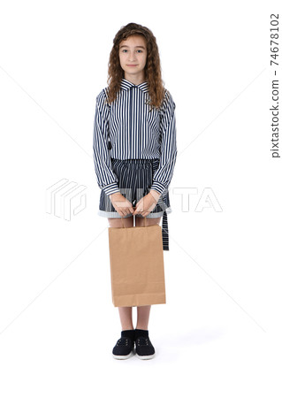 Child with a packet isolated on white 74678102