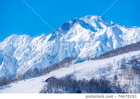 Snow-capped Northern Alps seen from Hakuba Village in winter [Nagano Prefecture] 74678283