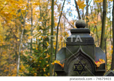 old gravestone in the autumn Jewish cemetery. graveyard landscape old gravestone in the autumn Jewish cemetery. graveyard landscape 74679403