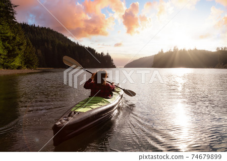 Adventurous Girl kayaking in the Pacific Ocean. Adventurous Girl kayaking in the Pacific Ocean. 74679899