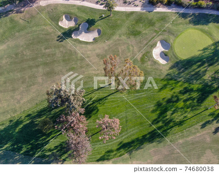 Aerial view over golf field. Aerial view over golf field. 74680038
